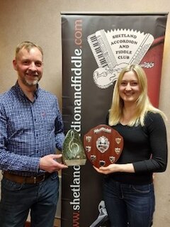 Kirsten Hendry being present with her trophies from Club Treasurer Scott Lobban